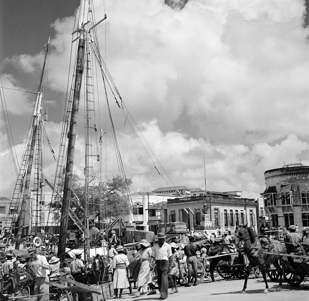 A view of the local harbor and sailing ships in Bridgetown, 1940s