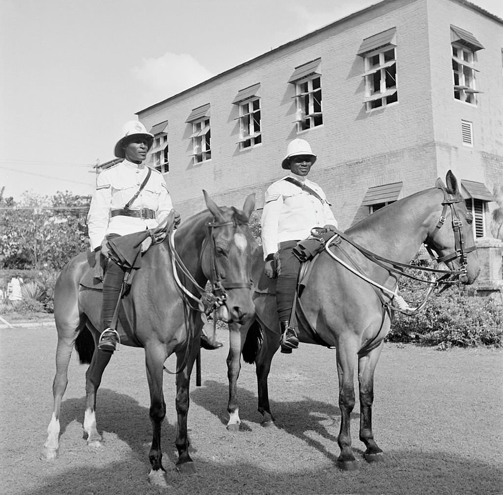 Two mounted police pose on their horses in Bridgetown, 1946
