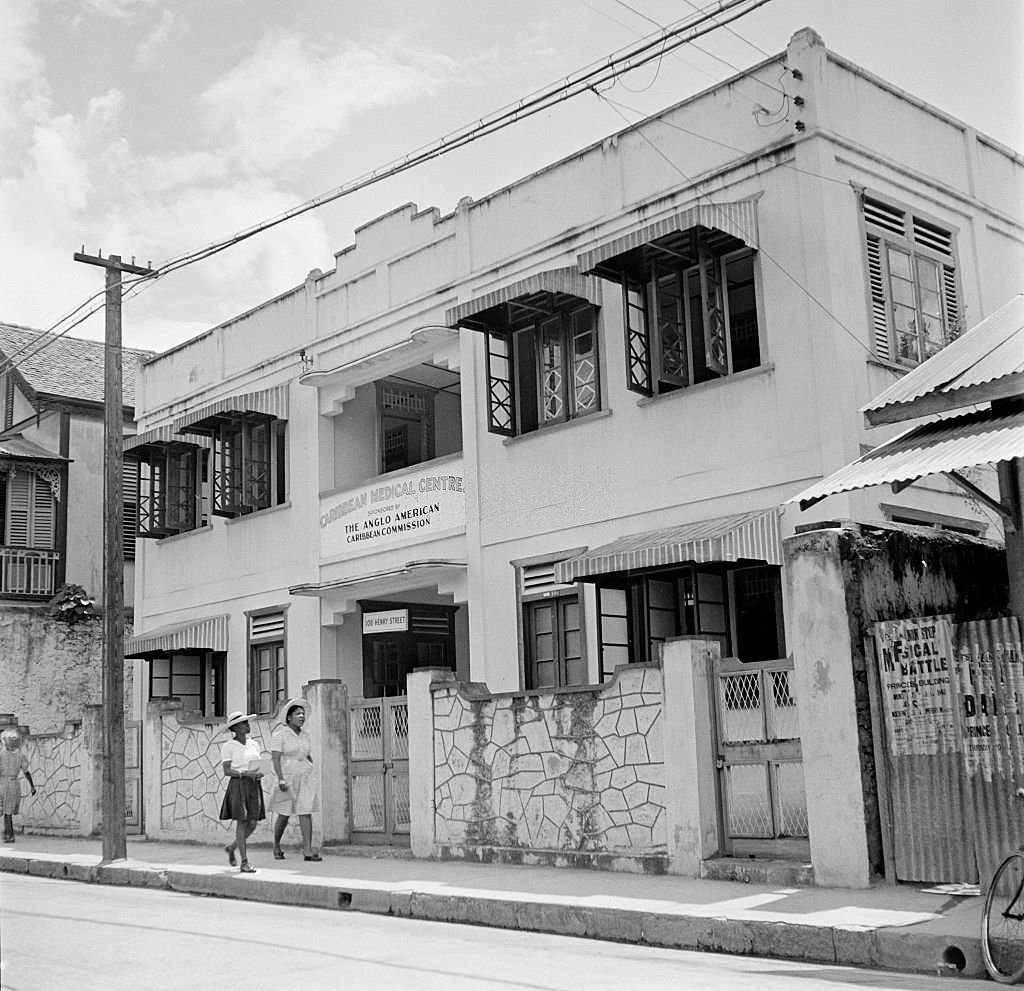 Two women walk past the Caribbean Medical Center in Bridgetown, 1946