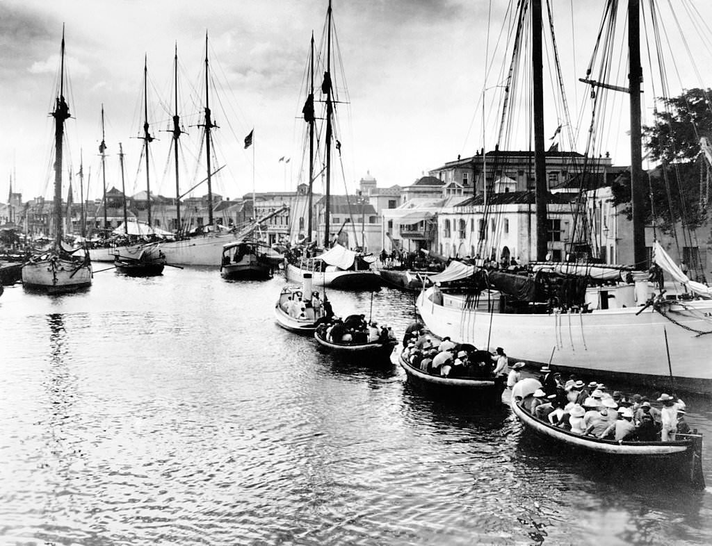 The Inner Harbour of Bridgetown, Barbados showing tourists being taken out to deeper water to join their cruise ship, 1910.