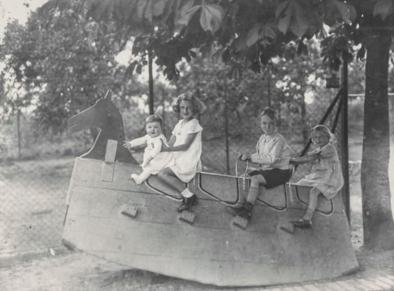Children riding an oversized rocking horse, 1930s