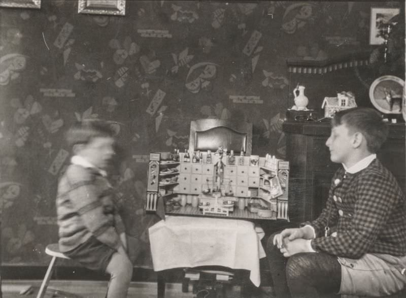 Little boys examining a kitchen diorama, 1930
