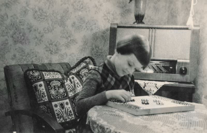Little girl playing a board game, 1930s