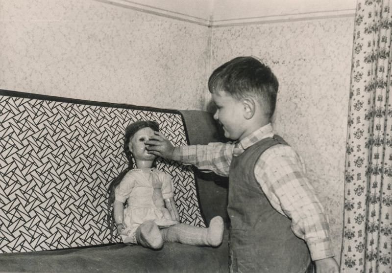 Little boy feeding a doll