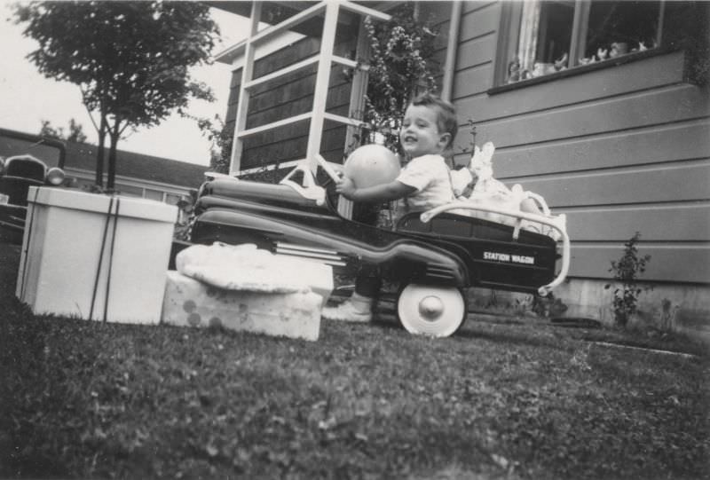 Little boy riding in a toy car