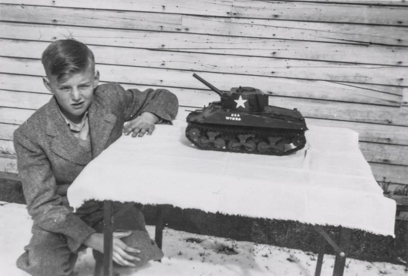 Little boy showing off a toy tank
