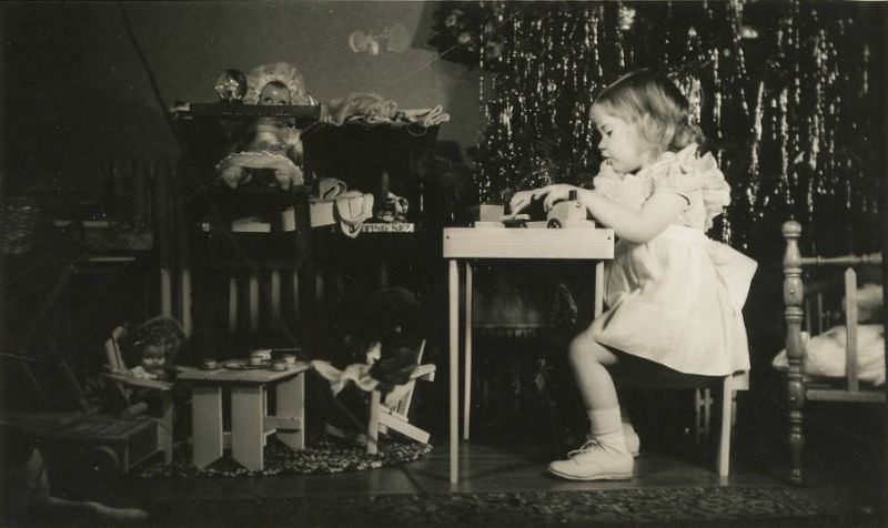 Little girl plays with her antique toys