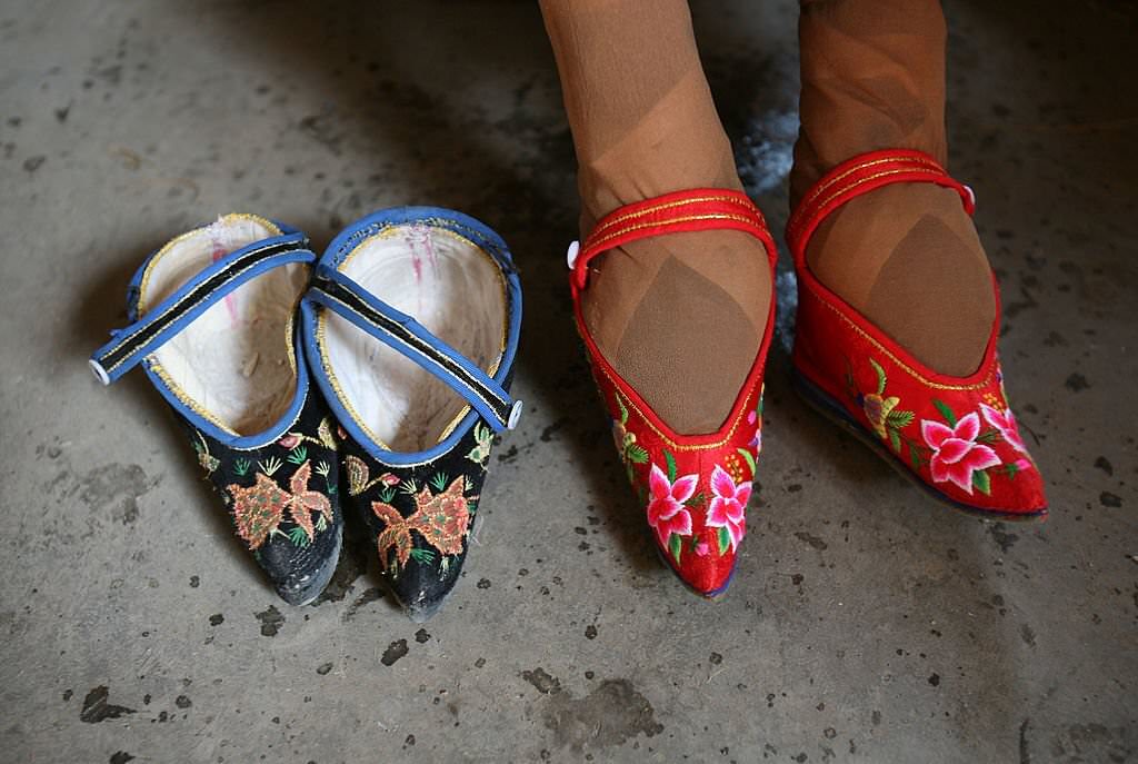 82-year-old bound feet woman Fu Jifen, displays "Three Cuns Golden Lotus" shoes she made at Liuyi Village on April 2, 2007.