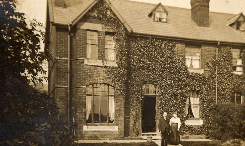 Couple in front of large house