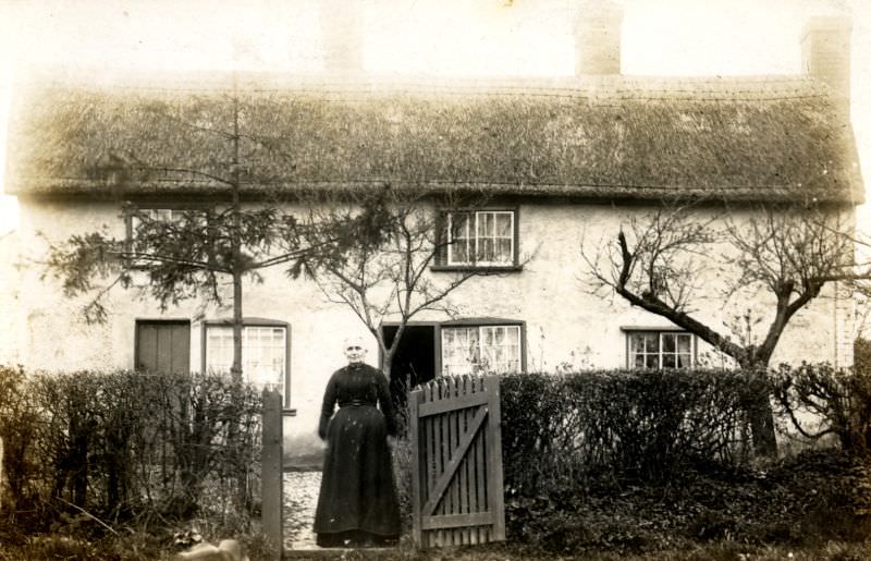 In front of straw-thatched cottages