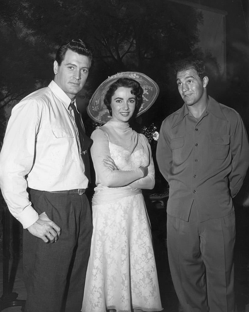 Elizabeth Taylor and American prizefighter Rocky Marciano (1923 - 1969) pose on the set of director George Stevens' film, 'Giant'