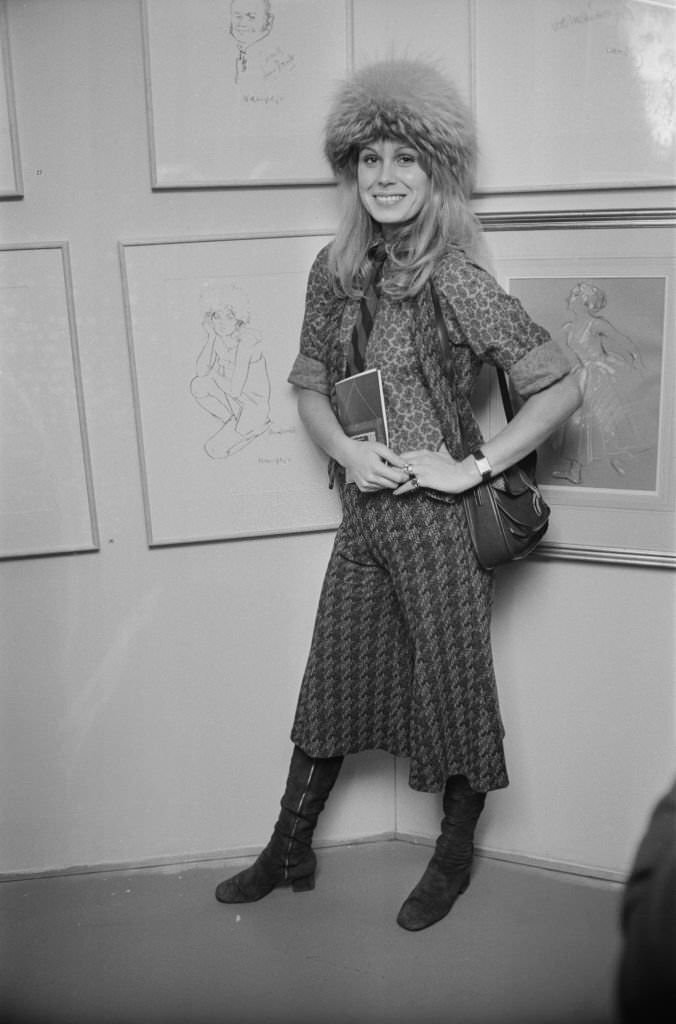 Actress Joanna Lumley stands by a drawing of herself by Trevor Willoughby at a Royal Academy exhibition of 'Stars on Canvas'.