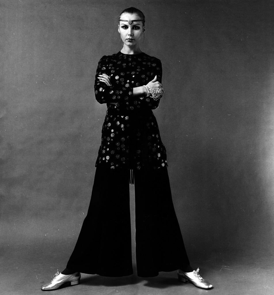 A model wearing a tunic top and crepe wide-legged trousers.