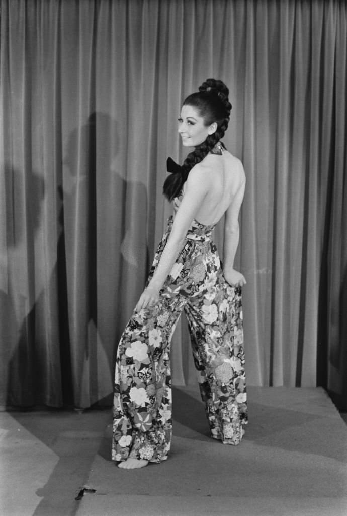 A model wearing halterneck culottes in a floral butterfly pattern.