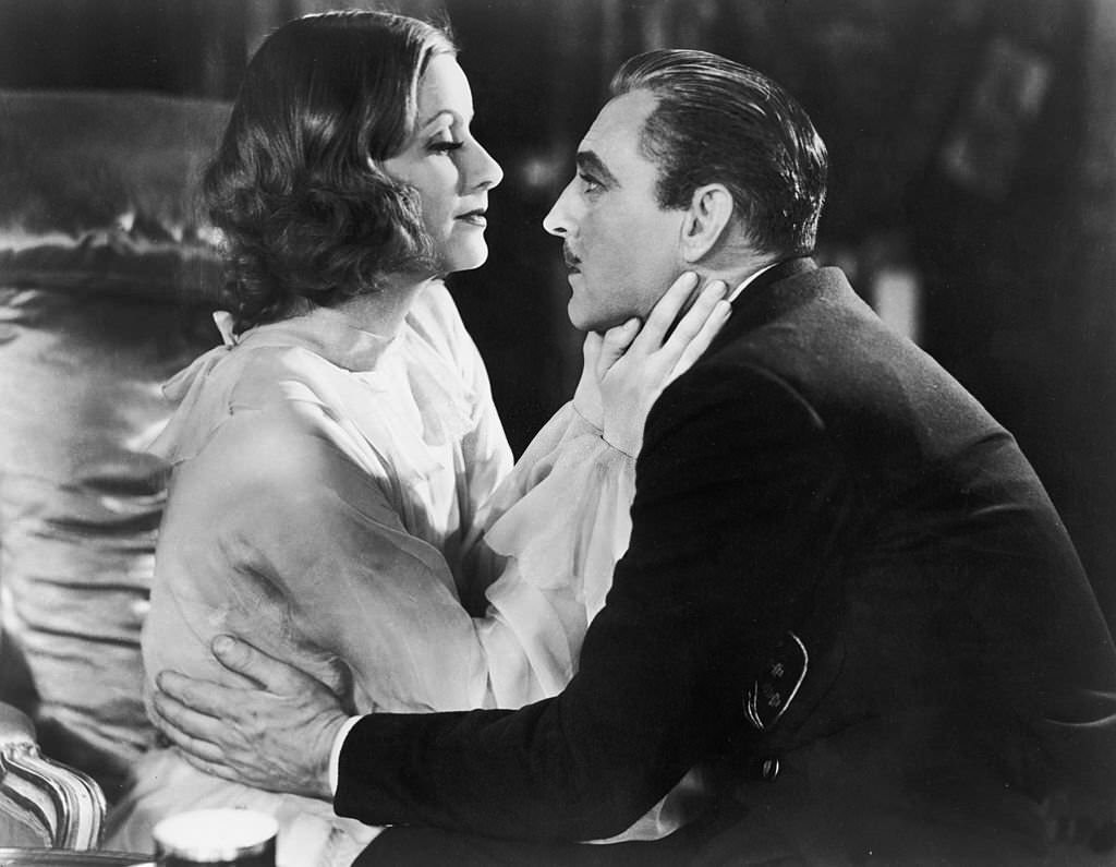 Greta Garbo embraces American actor John Barrymore ) in a still from the film, 'Grand Hotel,' 1932