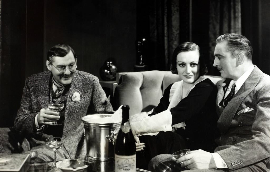 Lionel Barrymore, left, appearing with his brother John Barrymore and Joan Crawford, centre, in the film 'Grand Hotel', 1932