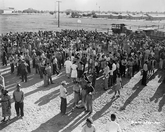 A large group of Japanese American detainees at an assembly center awaiting transportation to a relocation center.