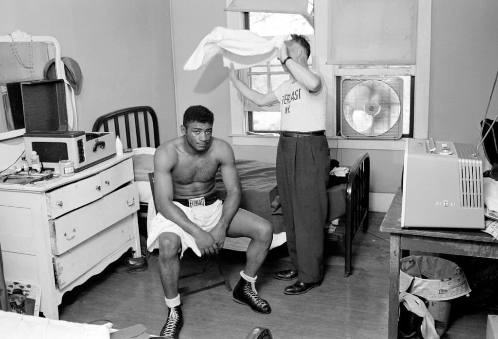 Floyd Patterson being fanned with a towel in his room at Ehsan's training camp, 1959