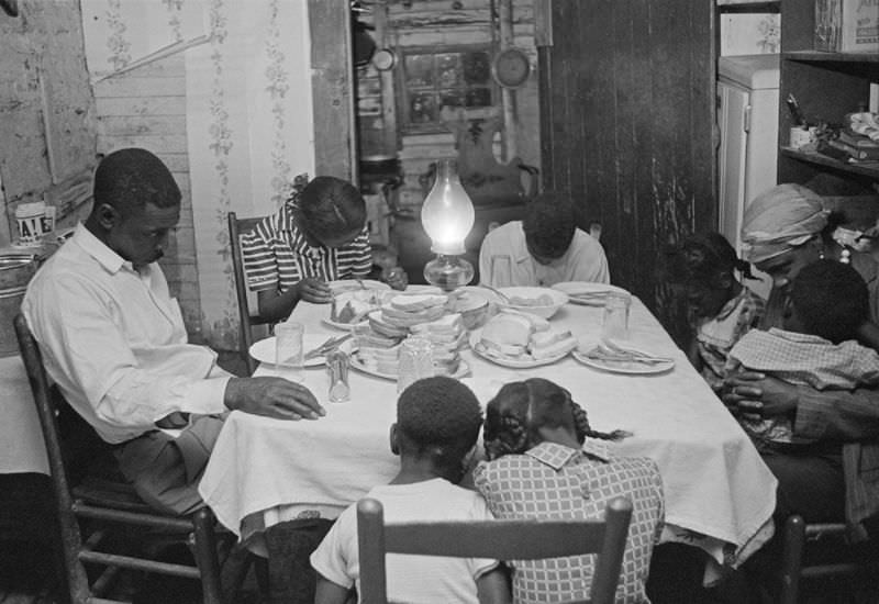 Matt Ingram, wife Linward and their children pray before dinner, Yanceyville, North Carolina, 1953.