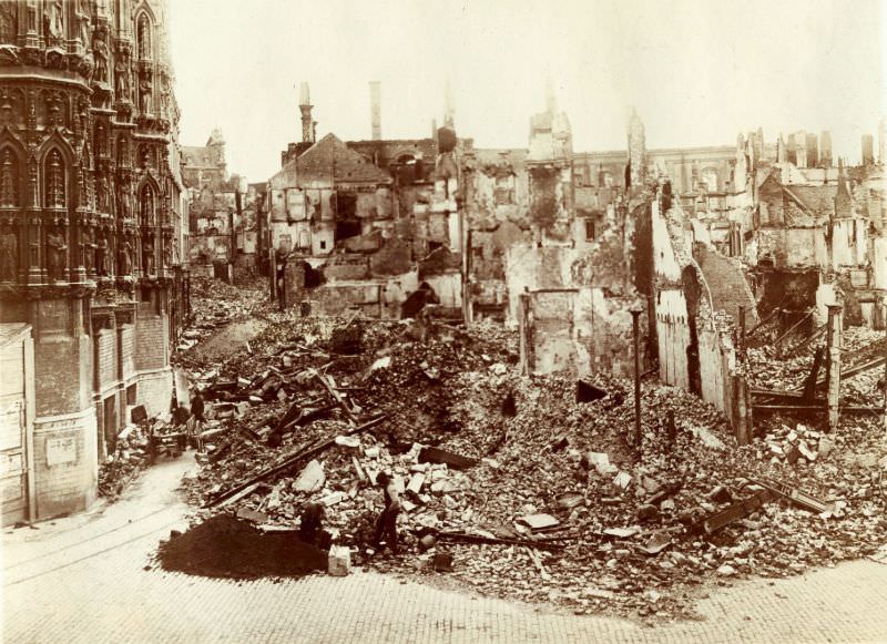 Block of houses between Naamsestraat and Kortestraat completely destroyed. City Hall is on the left, Leuven, August 1914