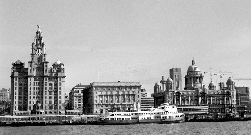 Royal Liver Building in Liverpool, left, with the Mersey ferry on its way along the River Mersey.