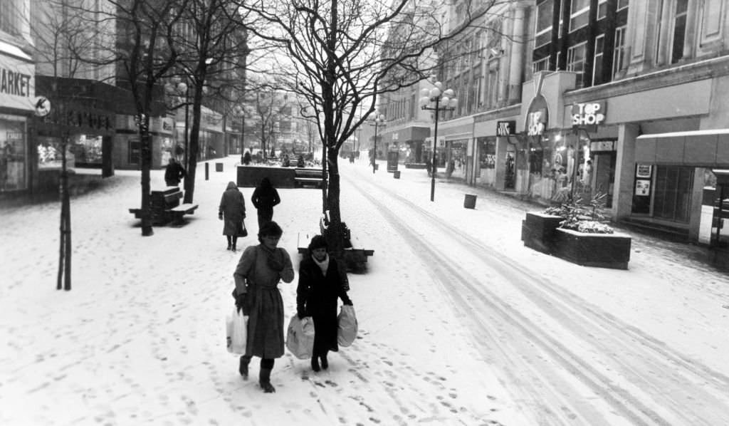 Huddled up against the winter snow, shoppers in a strangely quiet Church Street during the morning, 11th February 1985.