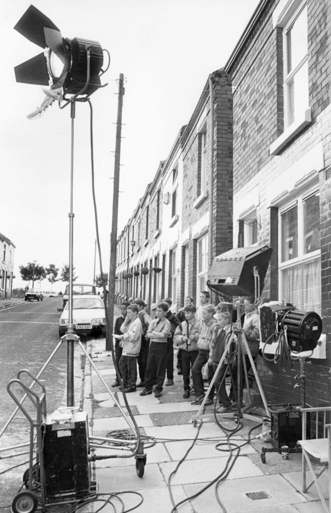 Local children and their friends gather on Elswick Street, Dingle, to see the cast and crew of the BBC hit comedy Bread filming for the next series, 10th July 1988.