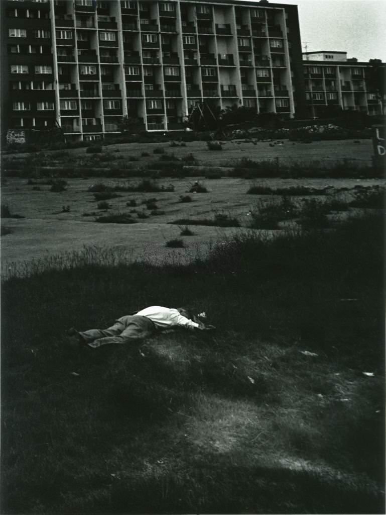 A man sleeping on waste ground in Liverpool, June 1982.