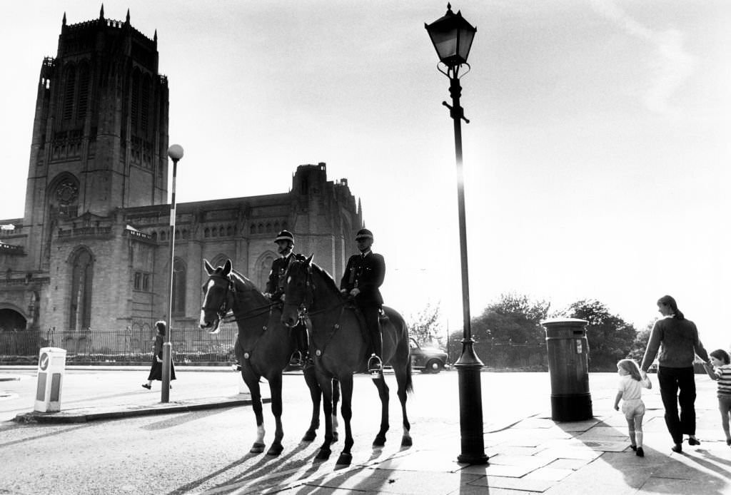 Police mounted on horses patrol the area around Liverpool Anglican Cathedral, 6th September 1989.