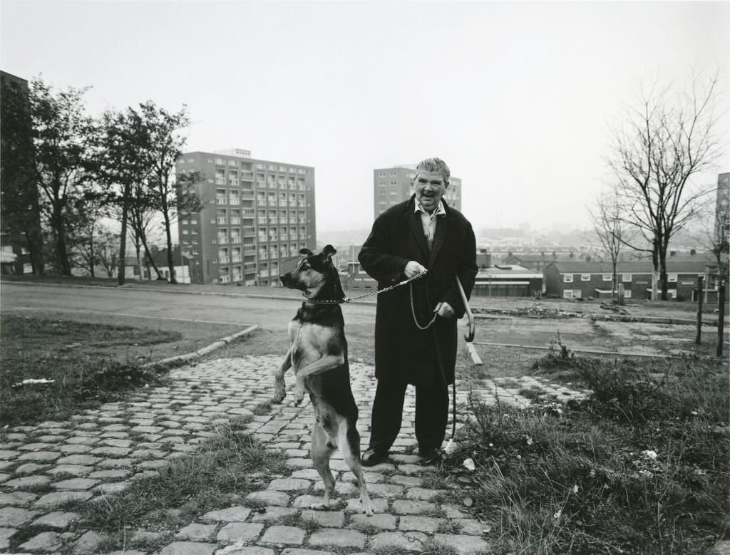 A man taking his dog for a walk in Liverpool, 1982.