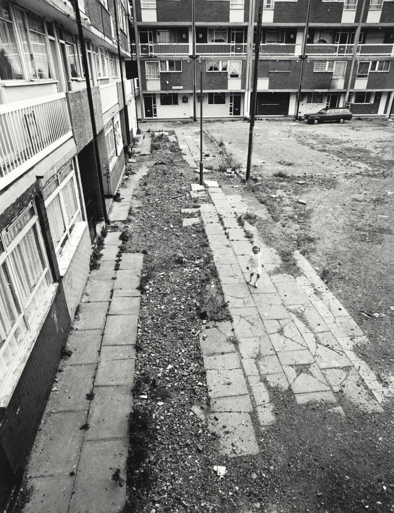 A small child outside her home in Liverpool, 1982.