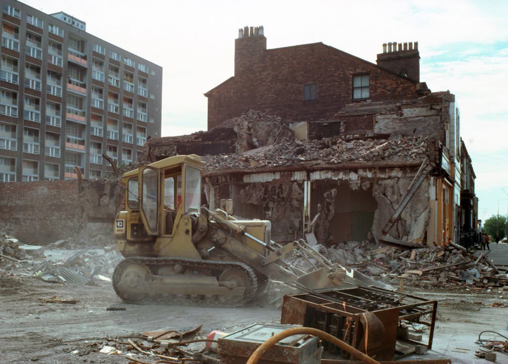 Remnants of the Rialto Ballroom (later Swainbanks' second-hand furniture emporium) being demolished after it was burned during the Toxteth Riots, August 1981 in Liverpool.
