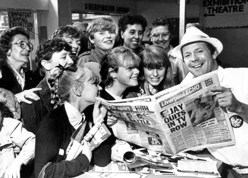 DJ Billy Butler shows off the new style of tabloid Liverpool Echo to visitors to the Echo Ideal Home Exhibition, 7th September 1983.