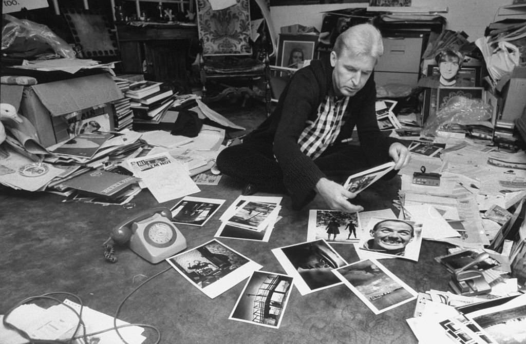 Photographer Mike McCartney, brother of Paul McCartney, at home going through photos.