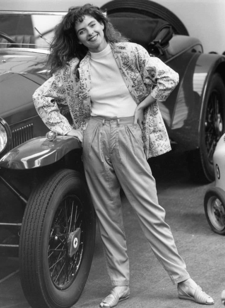 Model wears apple green trousers with green white pattern jacket standing beside a 19-29 Lancia Lamda. 9th June 1986.