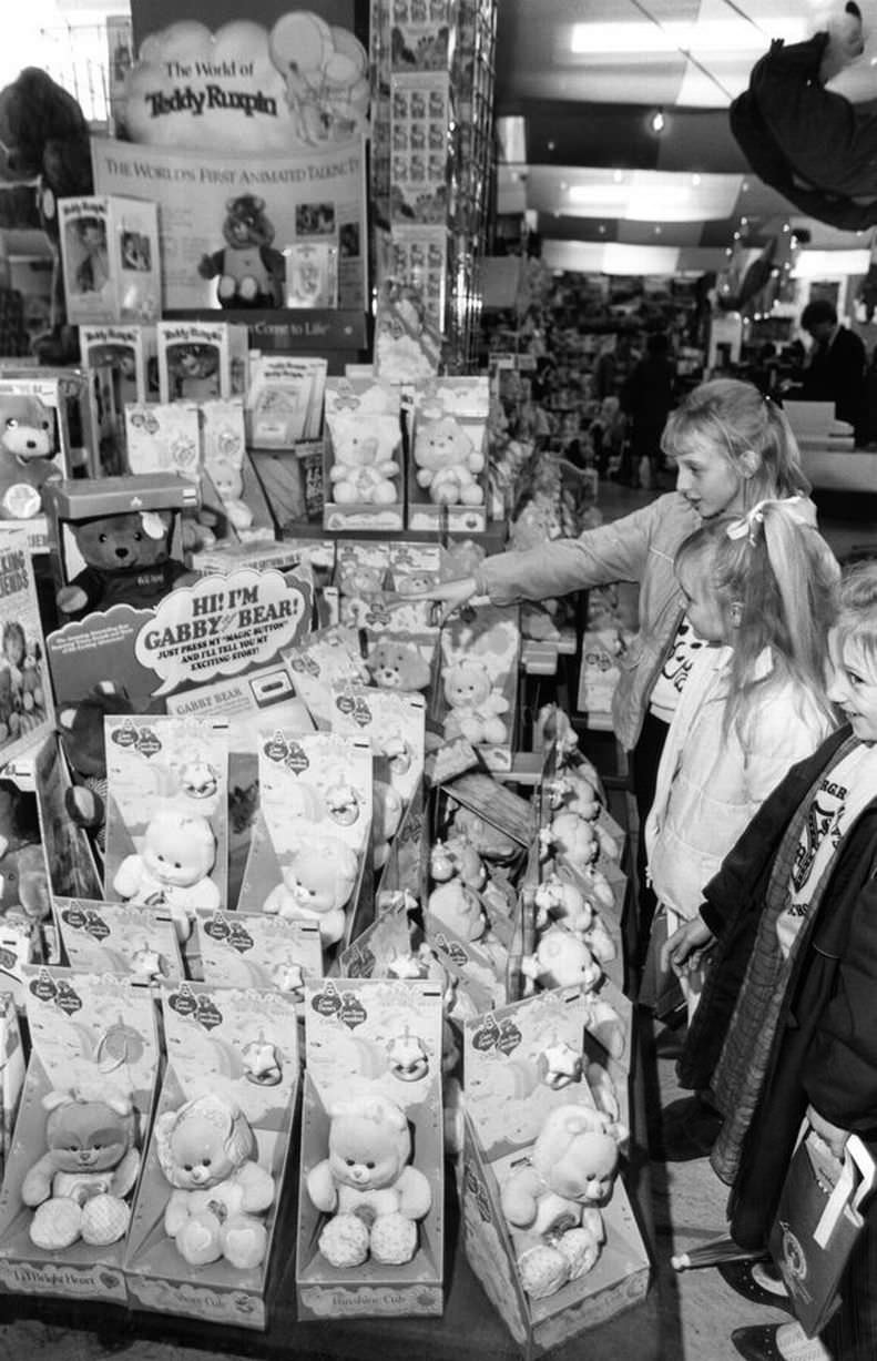 Christmas Shopping Trip, 25th November 1986. Young girls examine Gabby Bear Dolls