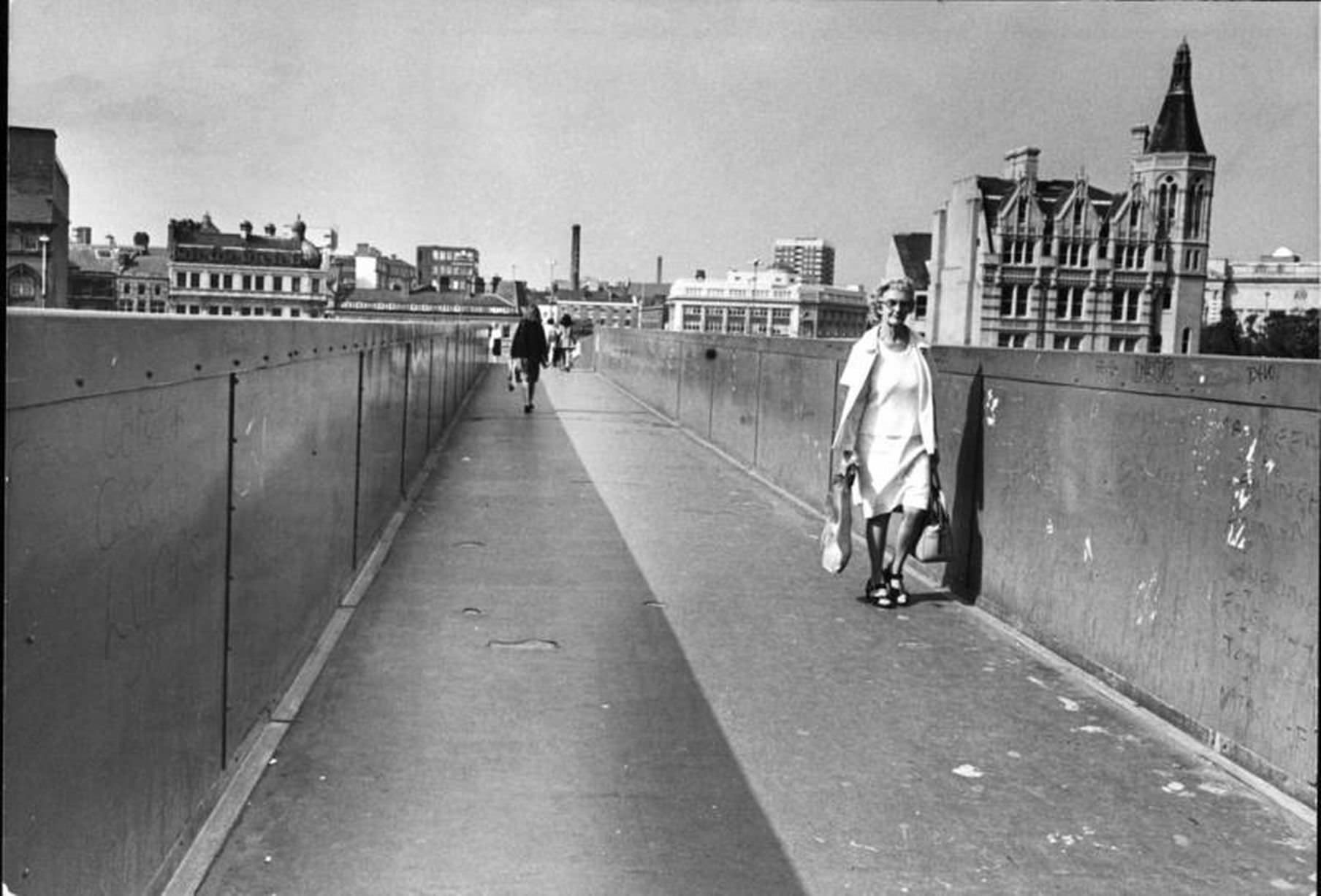 Picture shows pedestrians using the walkway, also known as the sky bridge, in Roe Street, Liverpool city centre.