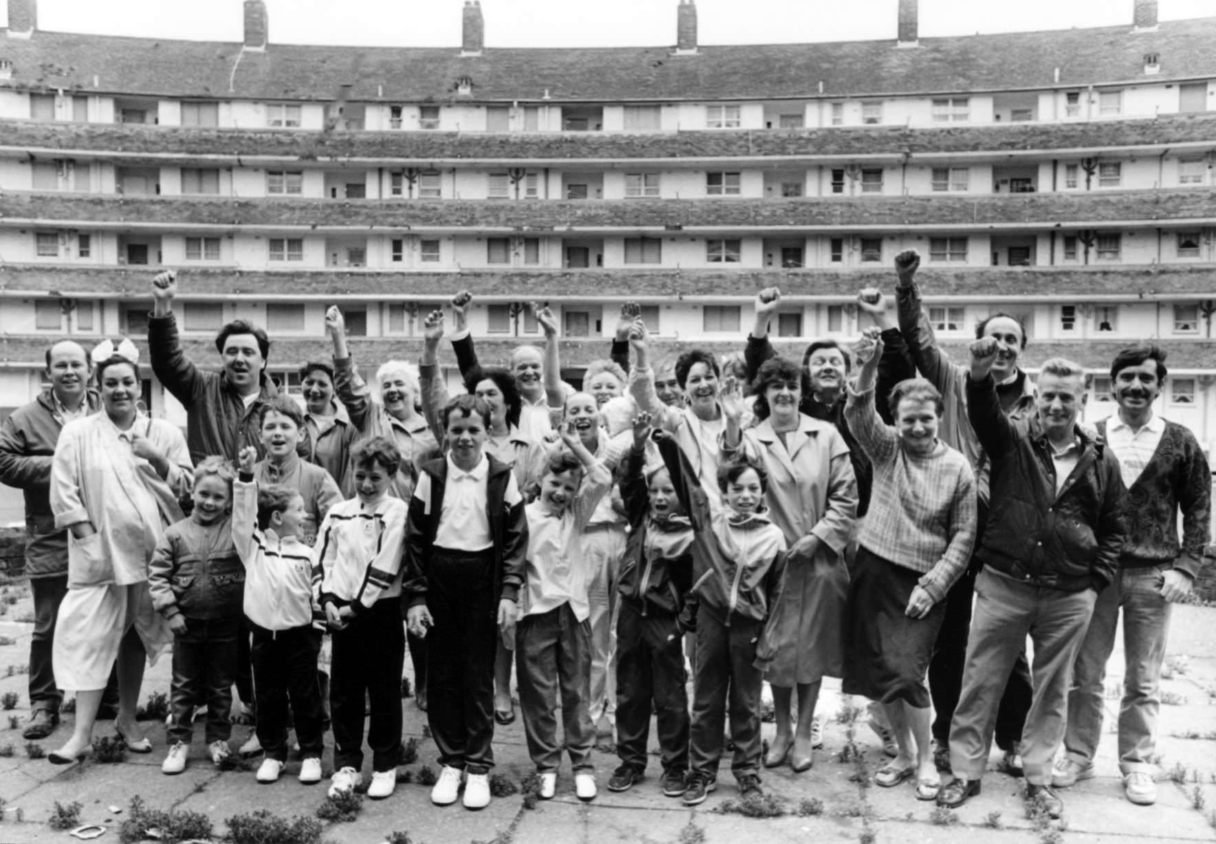 11 families of Gerard Gardens celebrate a victory over Liverpool City Council.