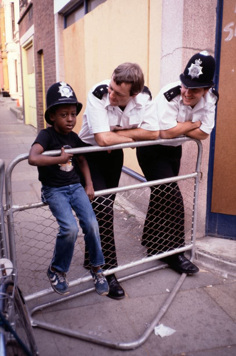 Police with young child in Toxteth, 1981