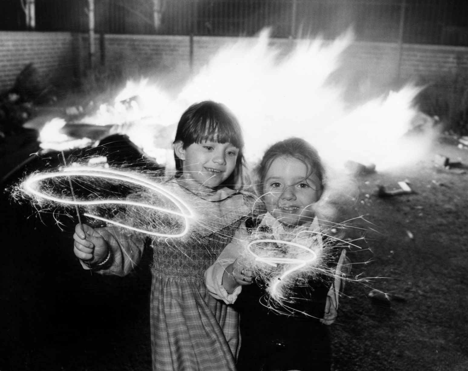 Clare aged 6 and Lindsay Gerard aged four (right) enjoying their sparklers at an impromptu bonfire party in Kensington, Liverpool, 1986