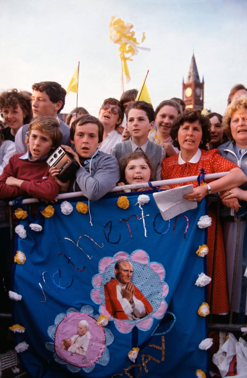 Children among the crowds to welcome Pope John Paul II on his visit to Liverpool in 1982
