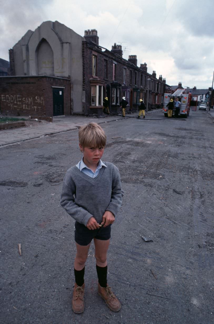 Boy standing in the street in Toxteth in 1981