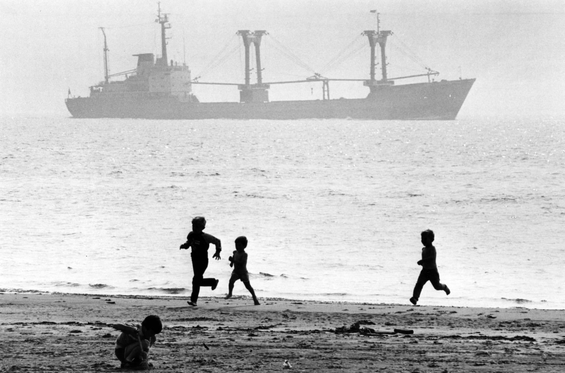 Children enjoying the summer holidays on Crosby beach. Crosby, Sefton, Merseyside. August 1984