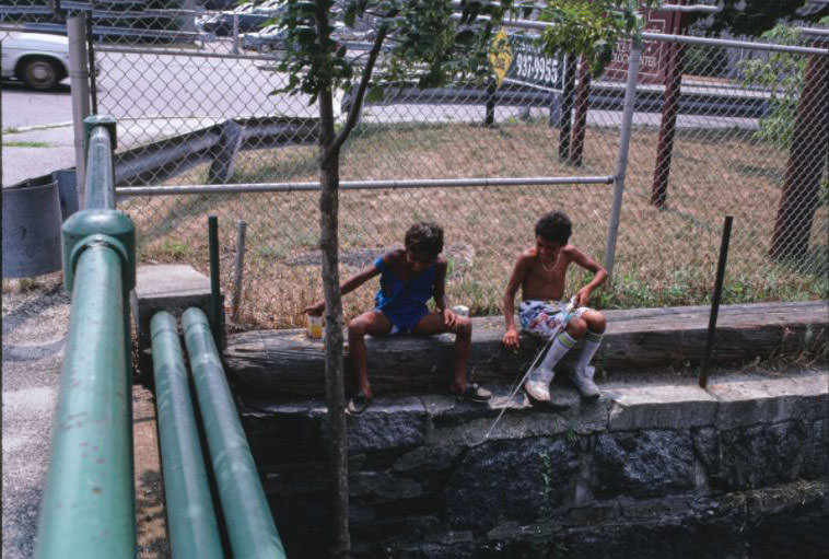 Boys playing and fishing near North Canal Housing Project.