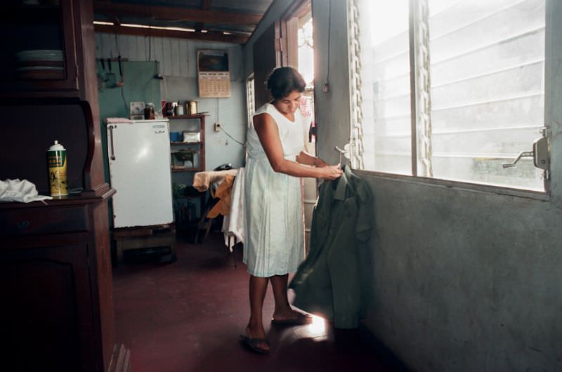 Elba, Julio's wife, irons his uniforms. They live with their son in the Montano home, Managua, Nicaragua, 1985