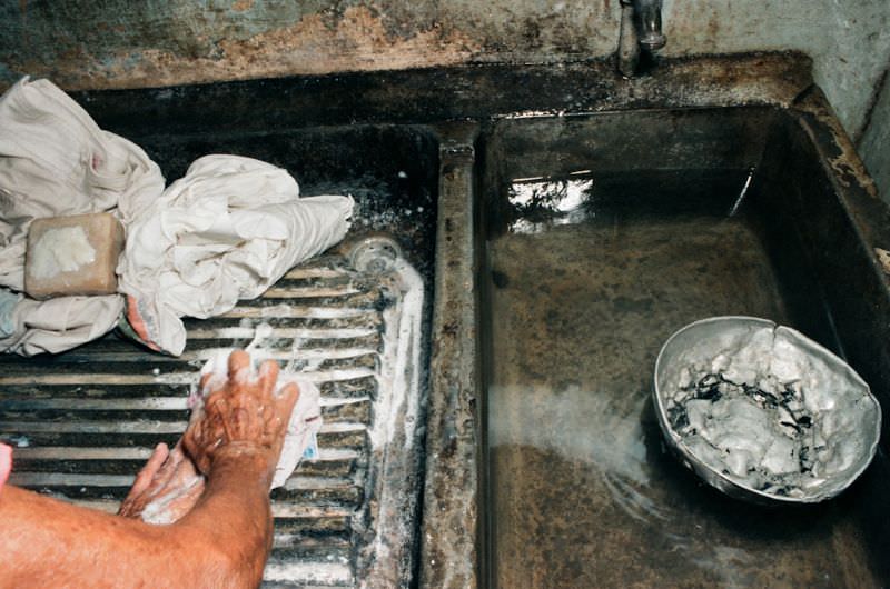 La Conchita, Doña Mercedes' sister, does the wash, Managua, Nicaragua, 1985