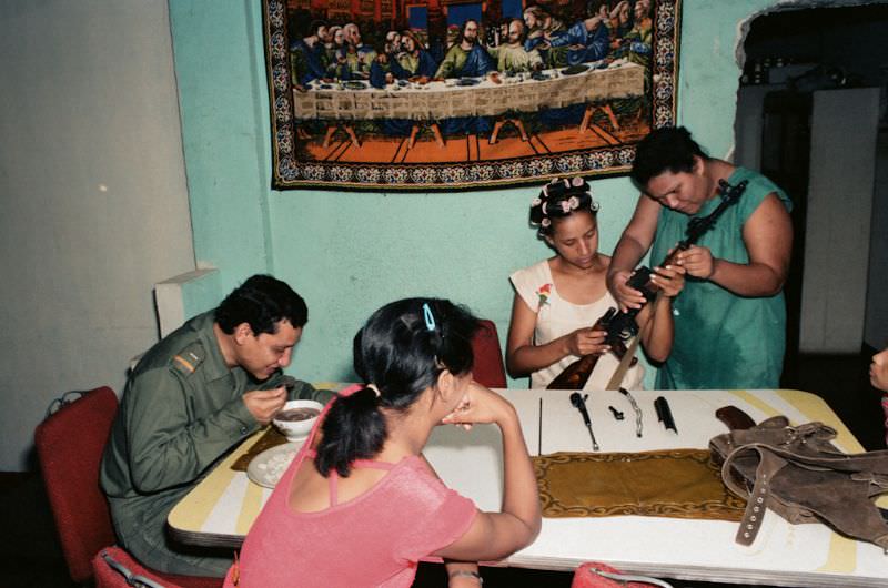 Milena and her cousins clean the gun to prepare for civil defense, Managua, Nicaragua, 1985