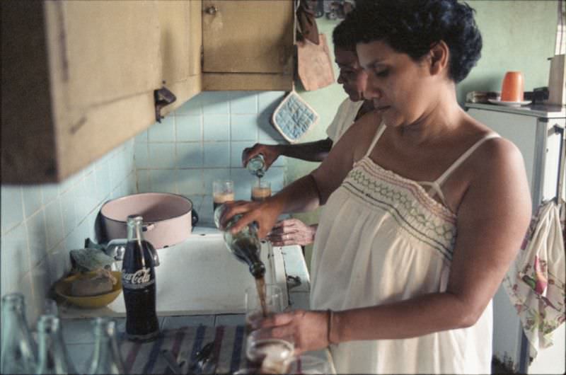 Angela and friend pour Coca-Cola, Managua, Nicaragua, 1985