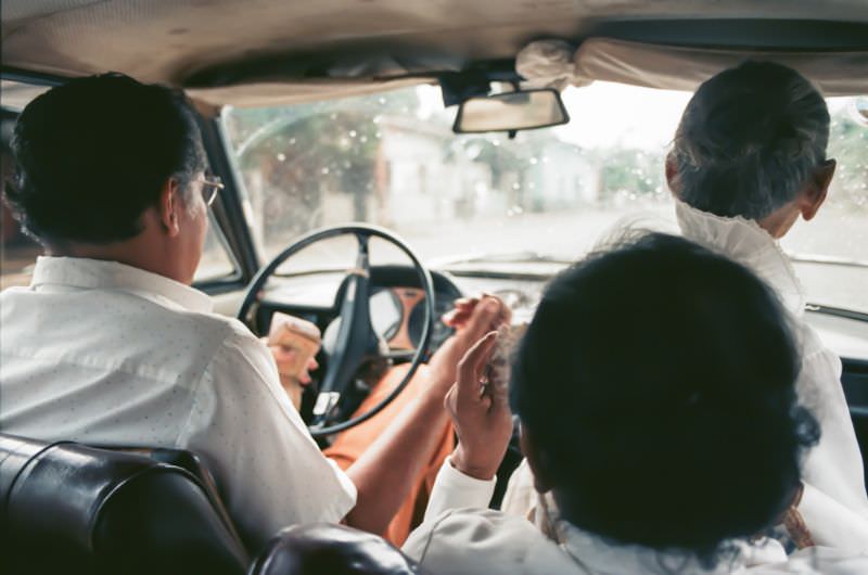 Doña Mercedes and her sister take an over-crowded taxi to the market, Managua, Nicaragua, 1985