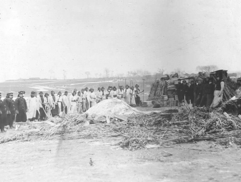 Stacks of unburned coffins and pile of ashes covered with lime, Changchun